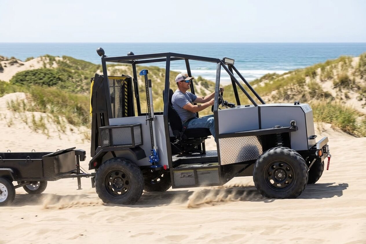 The Enabler 2.0 towing a trailer across coastal sand dunes