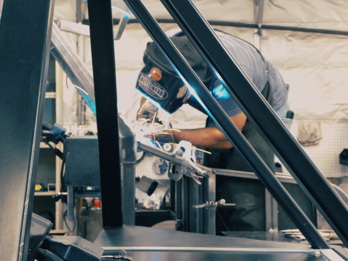 Welder working inside the Enabler's frame